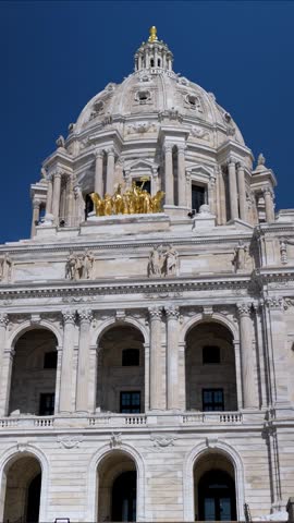 View the State Capitol in St Paul Minnesota showcasing its grand architecture and vibrant surroundings on a sunny day.