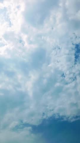 Beautiful view of sunlight shining through clouds in a blue sky, perfect for nature background and peaceful atmosphere.