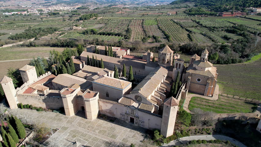 Orbital drone footage of Poblet Monastery on sunny winter day. Tarragona Province, Spain.