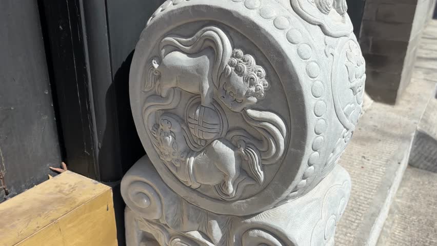 Traditional Chinese stone lion pedestal, featuring two lions playing with a silk ball, showcasing intricate carvings and cultural heritage.