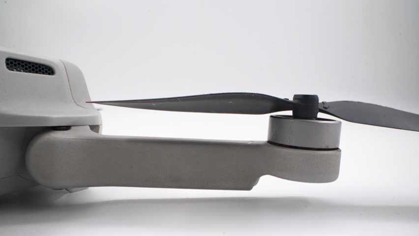 Close up of drone propeller and motor on white background
