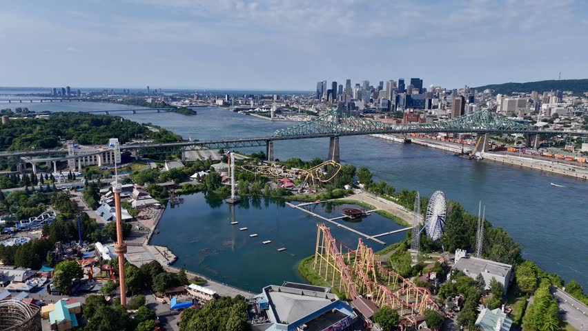 Aerial view of Montreal skyline, Jacques Cartier Bridge and La Ronde amusement island on St Lawrence River. g.
