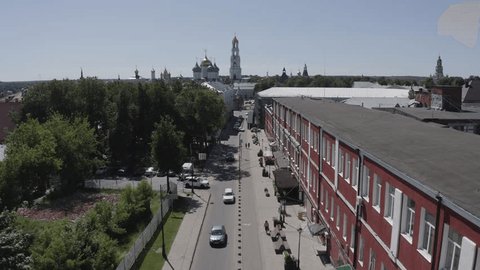 Drone Moving Forward above Urban Street Buildings