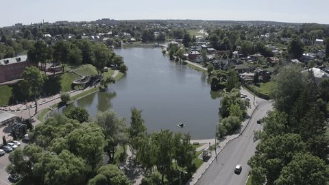 Drone Moving Forward Down over Urban Pond