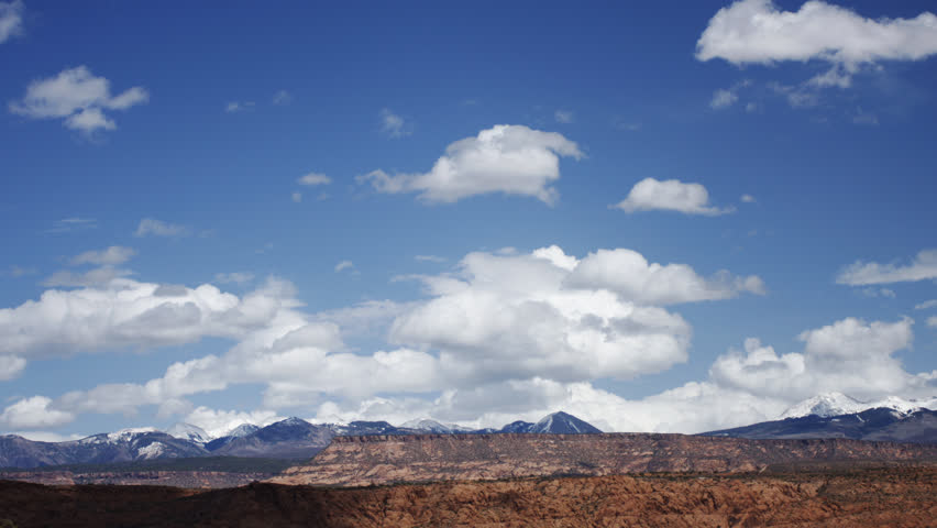 Active Cumulus clouds form and build in the spring sky, over the desert of Utah,