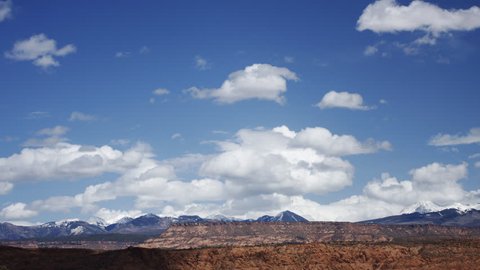 Active Cumulus clouds form and build in the spring sky, over the desert of Utah, with mountains in the distance. HD 1080 - No birds, no flicker.