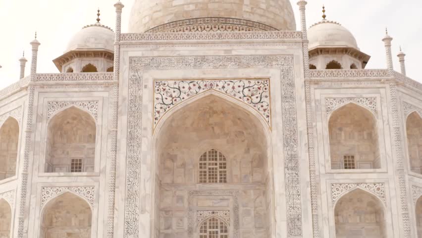 Taj Mahal in Agra India with tourists walking around, iconic world heritage monument, masterpiece of Mughal architecture and travel destination