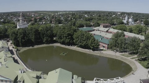 Circular Drone Ascent over Pond Urban Area