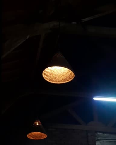 Traditional bamboo woven pendant lamps hanging in a rustic interior.