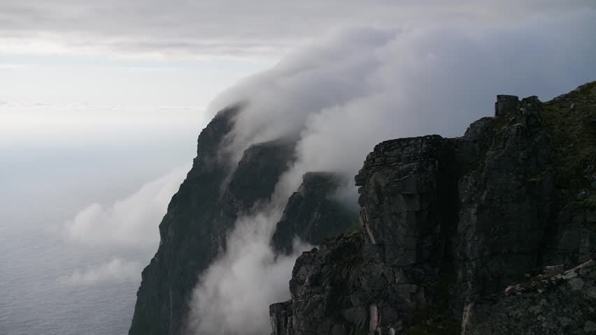 Sea fog rolling over coastal cliffs Norway