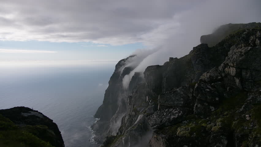 Sea fog over Lofoten cliffs Norway timelapse