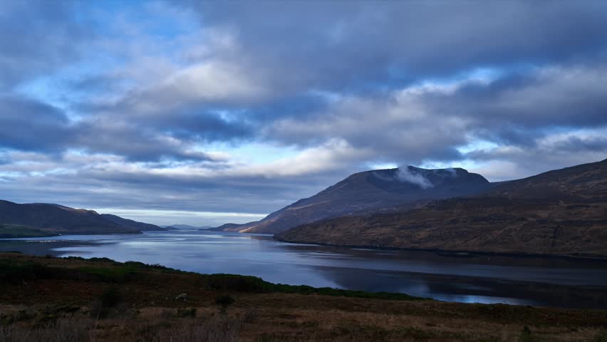 Time-lapse of candy floss clouds over the mountains. Shot during daytime with some amazing mountains in the backdrop. High quality Full HD footage