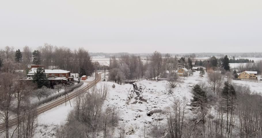 Aerial view of Kuhakoski rapids on the Luhtajoki river in cloudy winter weather, Nurmijärvi, Finland, Europe.