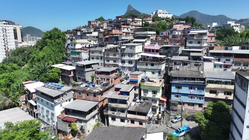 Slum Skyline In Rio De Janeiro In Brazil. Favela Aerial View. Tijuca Forest. Poor Houses Background. Slum Skyline In Rio De Janeiro In Brazil. Christ The Redeemer Mountain Top.
