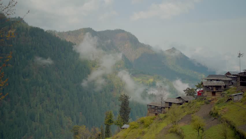 Clouds slowly moving over mountains in Himachal with a scenic view.