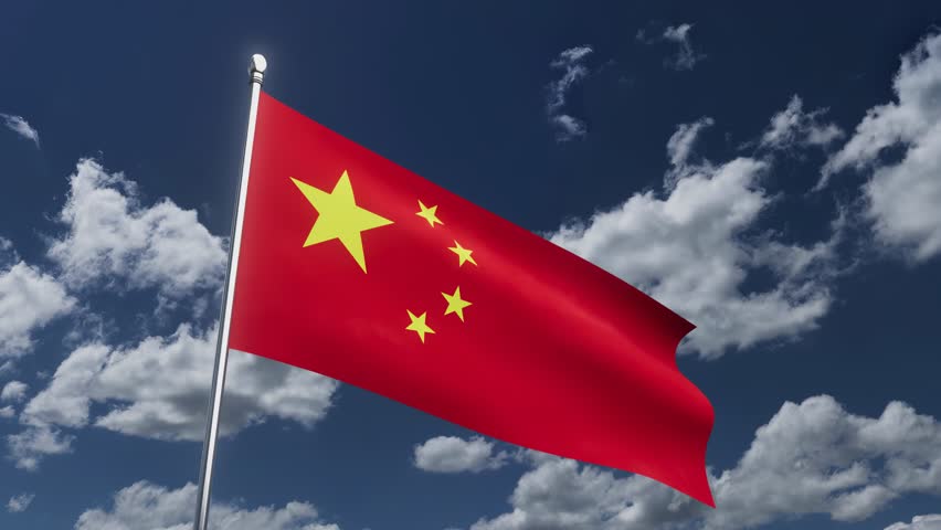 Chinese flag waving in the sky during a sunny day with clouds in the background.
