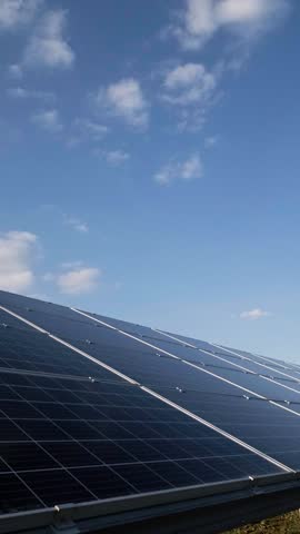 Solar panels under bright sun with blue sky, renewable energy concept