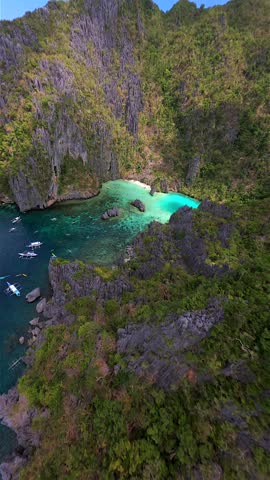 Cinematic FPV drone flight over Cadlao Lagoon in El Nido, Palawan, Philippines, with turquoise water, limestone cliffs, and boats in a hidden tropical paradise.