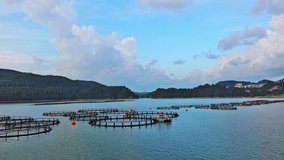 Fishing cages for breeding fish in lake in mountain valley of Rhodope Mountains under cloudy sky - Powered by Shutterstock - Get 15% off with code: PIKWIZARD15
