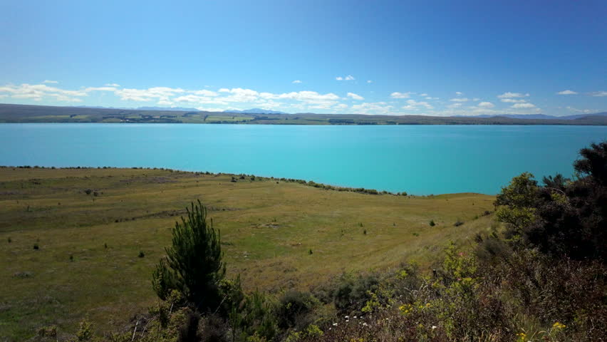 Wide Turquoise Lake Under Blue Sky