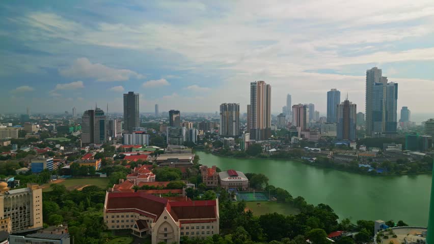 A stunning aerial drone view of Colombo, Sri Lanka, featuring the iconic Lotus Tower rising above the modern skyline. This cinematic cityscape captures urban development, coastal beauty, and architectural innovation in South Asia. Perfect for travel, tourism, business, and technology themes, the image highlights Colombo as a vibrant metropolitan hub with a mix of tradition and futuristic design.