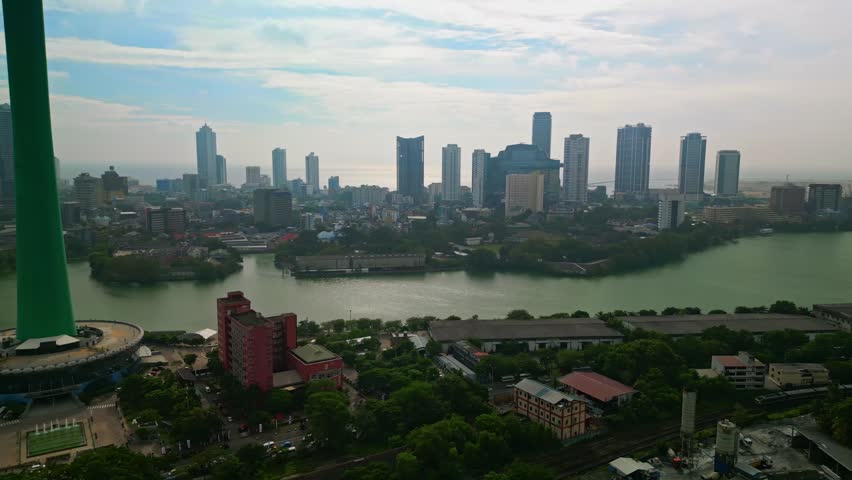 A stunning aerial drone view of Colombo, Sri Lanka, featuring the iconic Lotus Tower rising above the modern skyline. This cinematic cityscape captures urban development, coastal beauty, and architectural innovation in South Asia. Perfect for travel, tourism, business, and technology themes, the image highlights Colombo as a vibrant metropolitan hub with a mix of tradition and futuristic design.