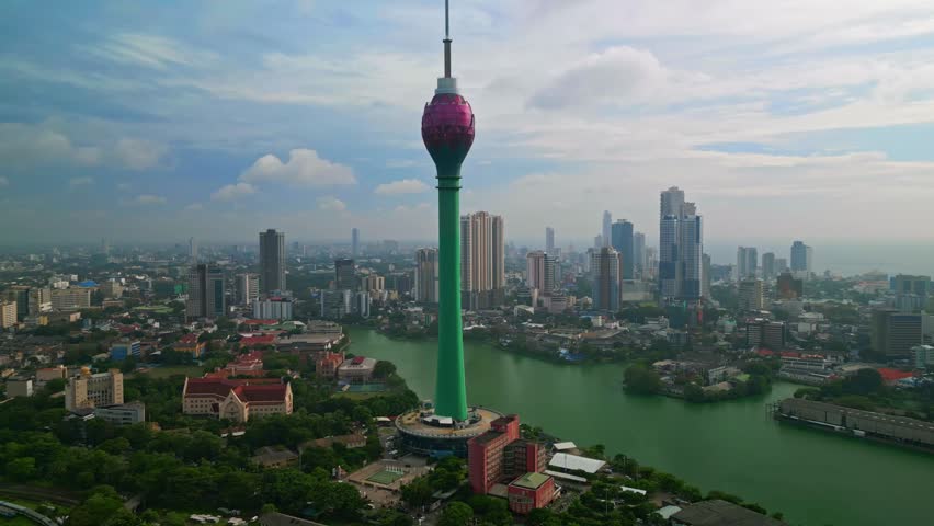 A stunning aerial drone view of Colombo, Sri Lanka, featuring the iconic Lotus Tower rising above the modern skyline. This cinematic cityscape captures urban development, coastal beauty, and architectural innovation in South Asia. Perfect for travel, tourism, business, and technology themes, the image highlights Colombo as a vibrant metropolitan hub with a mix of tradition and futuristic design.