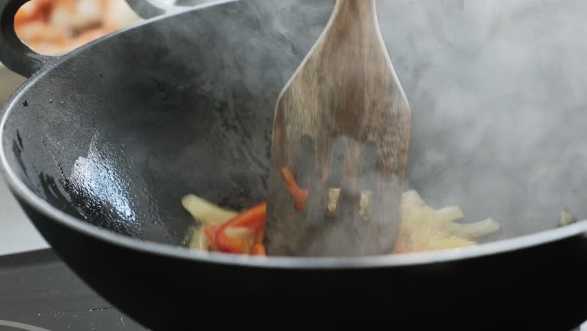 Chef Stirring Frying Vegetables In Steaming Wok With Spatula In Kitchen, Cooking Asian Wok Food