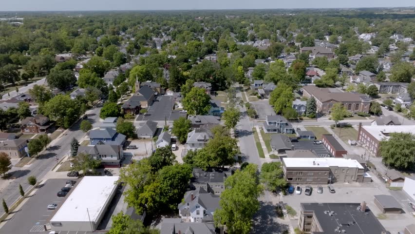 Neighborhood homes in Kokomo, Indiana with drone video moving in.