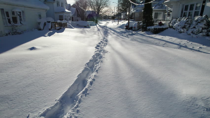 Aerial view of the blizzard of 2026 in Cranston, Rhode Island with impassable roads and snow covered roof tops.