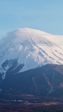 Mt fuji summit peak covered in white snow under clear blue sky during winter morning nature scenery.
