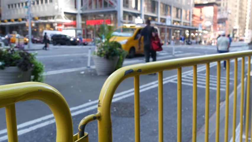 Manhattan Midtown street New York City, United States of America. Port authority bus terminal. Defocused car traffic on urban road, 8th avenue in Hells Kitchen. People pedestrian, yellow taxi cab.