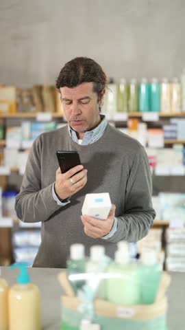 Adult man buyer scanning qr code for box of pills in pharmacy