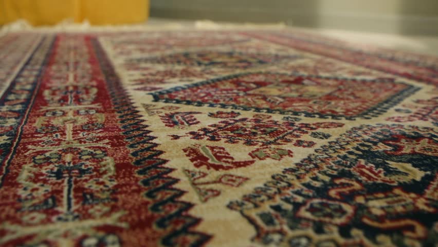 Detailed view traditional persian rug with intricate floral patterns, ornate borders, showing rich texture and colorful handmade craftsmanship of classic oriental textile. Traditional persian carpet.