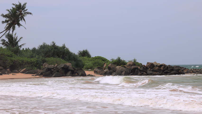 Tropical Ocean Waves on Sandy Beach with Palm Trees and Rocks: Relaxing Seascape, Nature Background, Vacation Travel Footage. Sri Lanka island in Asia.