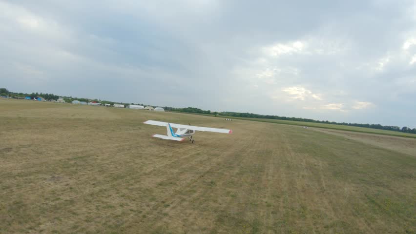 Airplane preparing for takeoff on a grassy airstrip, showcasing the gradual movement and positioning of the aircraft in a dynamic sequence, highlighting the anticipation of flight