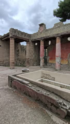 Herculaneum excavations featuring the House of the Telephus Relief, an ancient Roman residence with detailed artworks preserved by the eruption of Mount Vesuvius in Italy.
