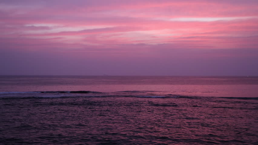 Ocean Waves Under Dramatic Purple and Pink Sunset Sky. The coast of the port city of Galle on the south-west coast of Sri Lanka.