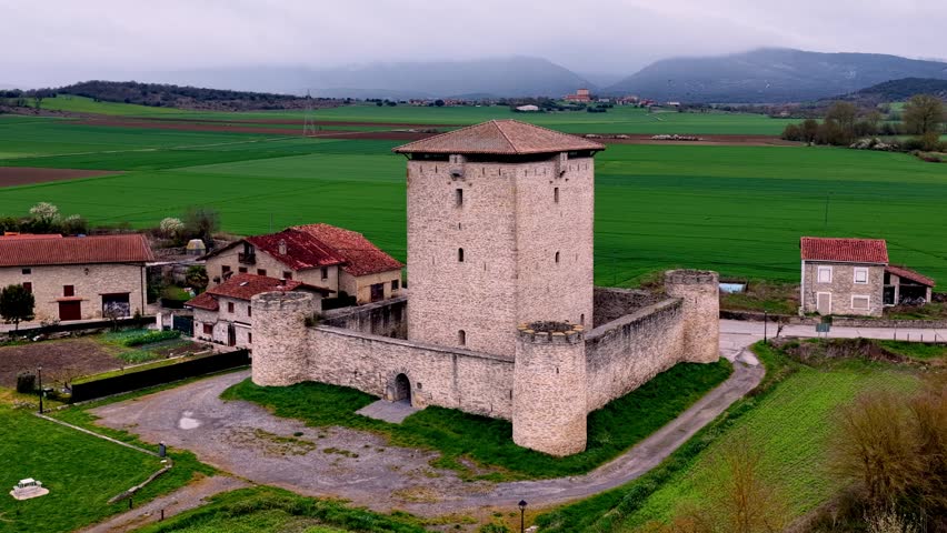 Cinematic aerial footage of the Tower of Mendoza, a historic medieval fortress located in Álava, Basque Country, Spain. Surrounded by green landscapes and traditional architecture, this iconic landmark reflects the region’s rich history and heritage. Ideal for travel, history, and documentary projects.