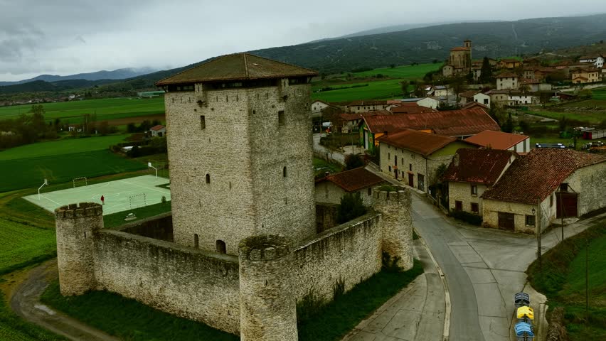 Cinematic aerial footage of the Tower of Mendoza, a historic medieval fortress located in Álava, Basque Country, Spain. Surrounded by green landscapes and traditional architecture, this iconic landmark reflects the region’s rich history and heritage. Ideal for travel, history, and documentary projects.