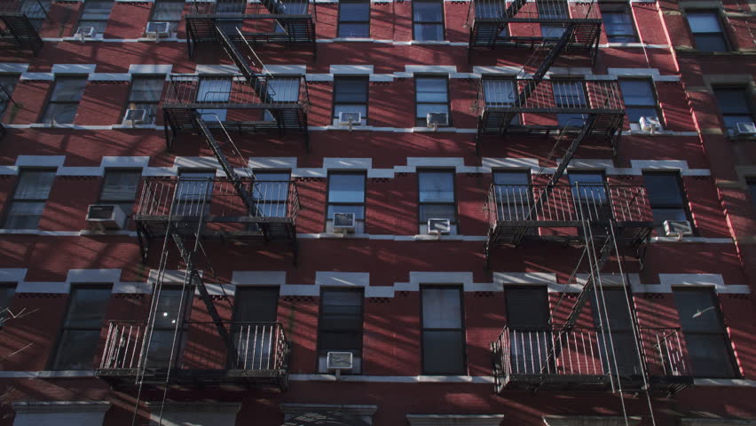 Handheld shot of a New York City apartment building.