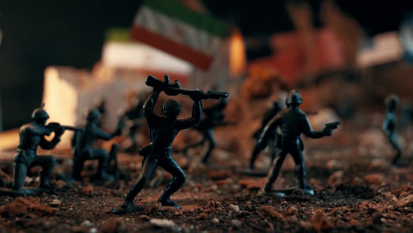 Plastic toy soldiers reenacting a battle scene on a miniature battlefield. Blue police and warm fire lights flashing over the war diorama