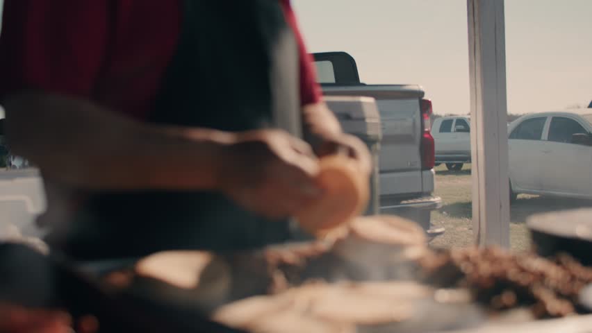 Cook Moving Meat and Tortillas Around on Grill While Cooking Outdoors
