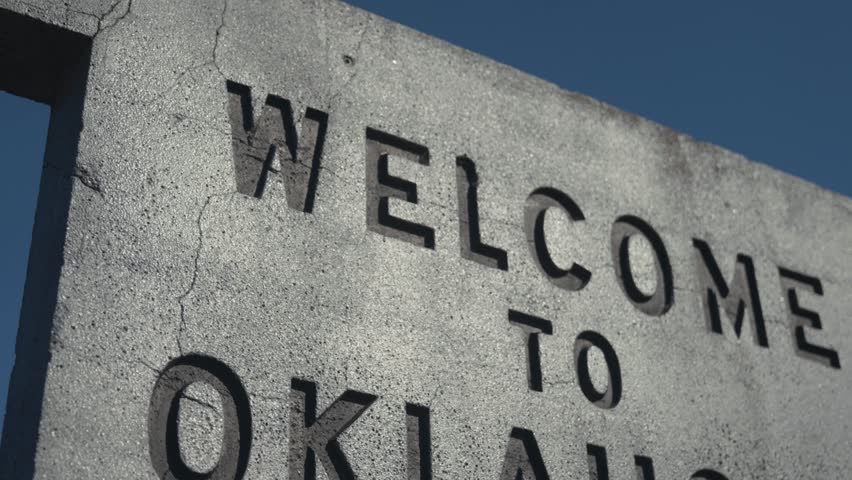 Close up of Gray Concrete Engraved Welcome to Oklahoma Sign at State Border 