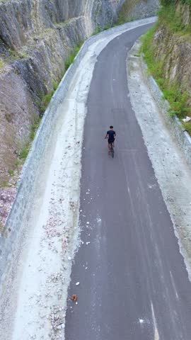 Aerial View of Man Riding Bicycle on Scenic Road