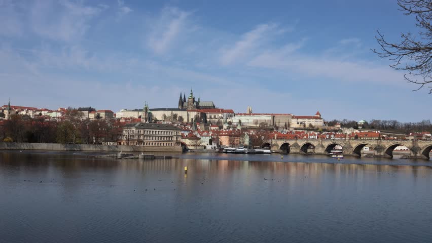 Panoramic view of Prague skyline with Charles Bridge and Prague Castle across Vltava river historic architecture travel destination calm spring atmosphere