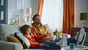 Smiling father playing popcorn watching television movie together at relaxed family leisure closeup. Carefree playful boy eating snacks enjoy TV viewing relaxing home couch. Parent child domestic life - Powered by Shutterstock - Get 15% off with code: PIKWIZARD15