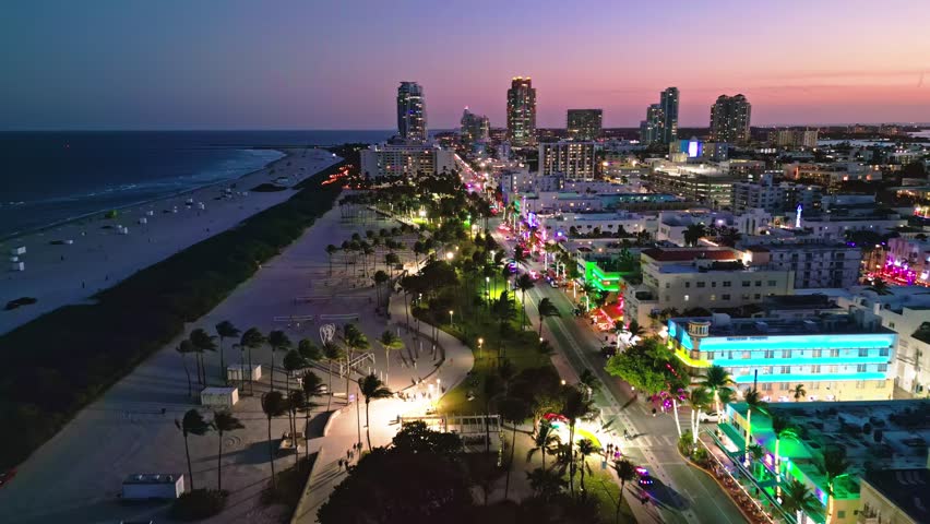 Miami beach sunset sky cityscape. Miami aerial skyline oceanfront. Miami waterfront coastal dusk. Miami Ocean drive seaside view.