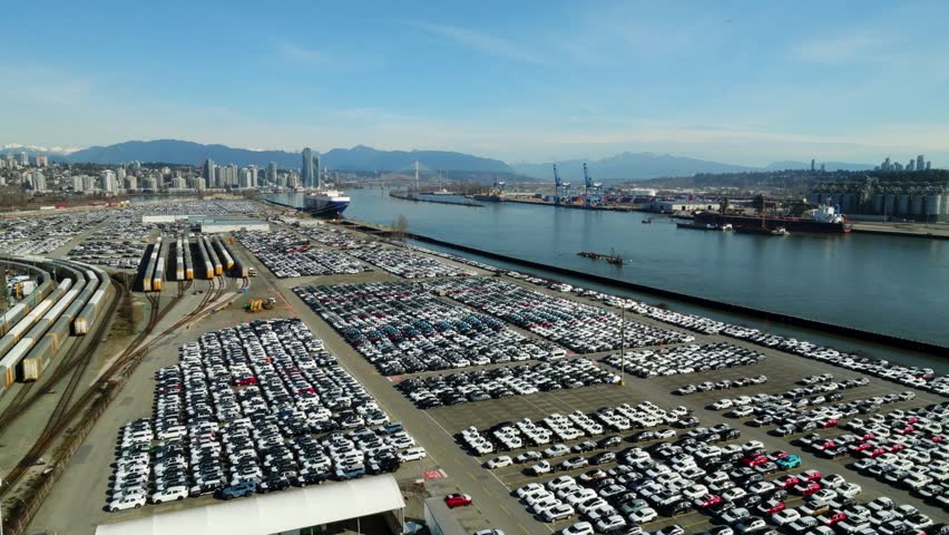 Major Hub For Importing Vehicles At Annacis Auto Terminal On The Fraser River In Delta, British Columbia, Canada. Aerial Ascending Shot