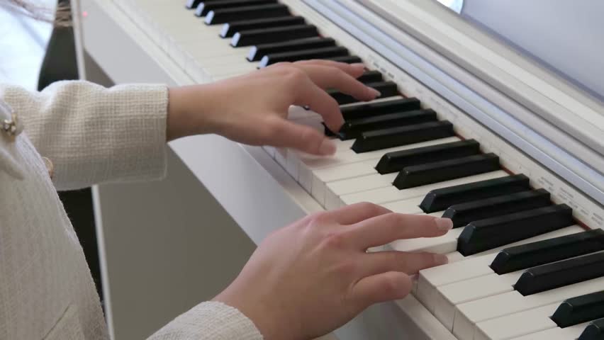 Female hands playing the piano